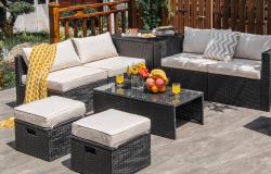 Weather-resistant wicker patio set with sofa and coffee table for backyard relaxation.