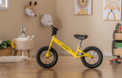 Yellow toddler balance bike in kids room
