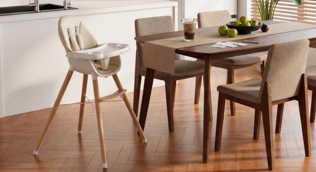 A baby high chair next to the dining table