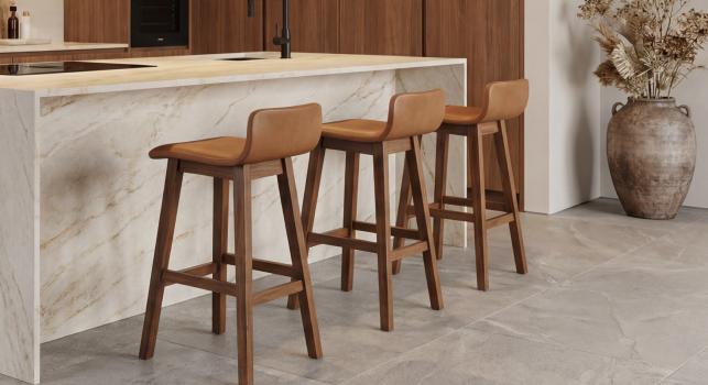 The dining room contains three brown bar stools.
